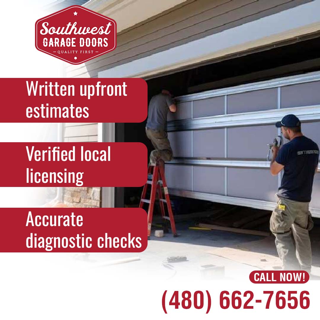 Two professional garage door technicians installing and adjusting an overhead garage door panel from a stepladder and the driveway.